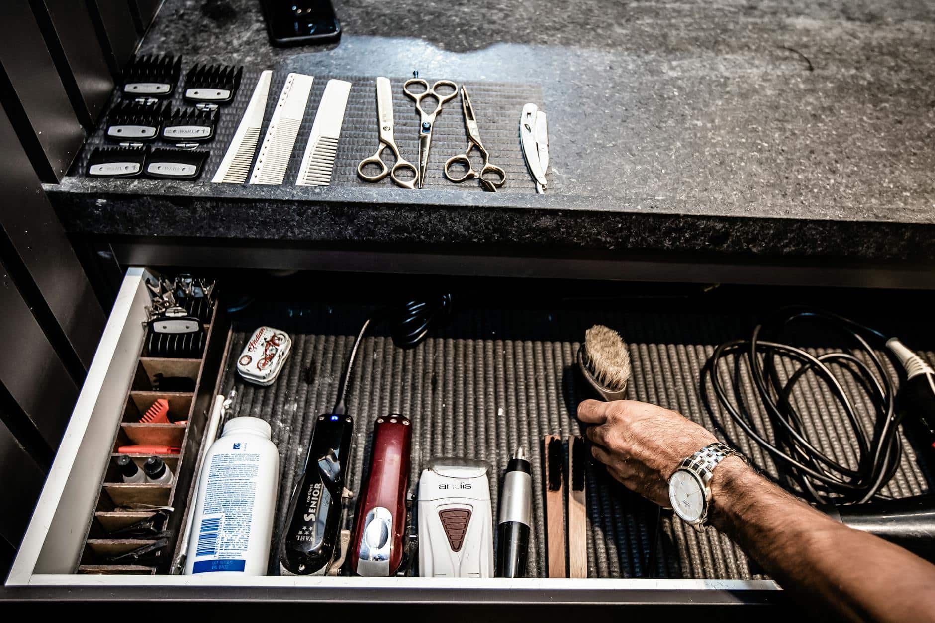 man putting hair brush on a drawer